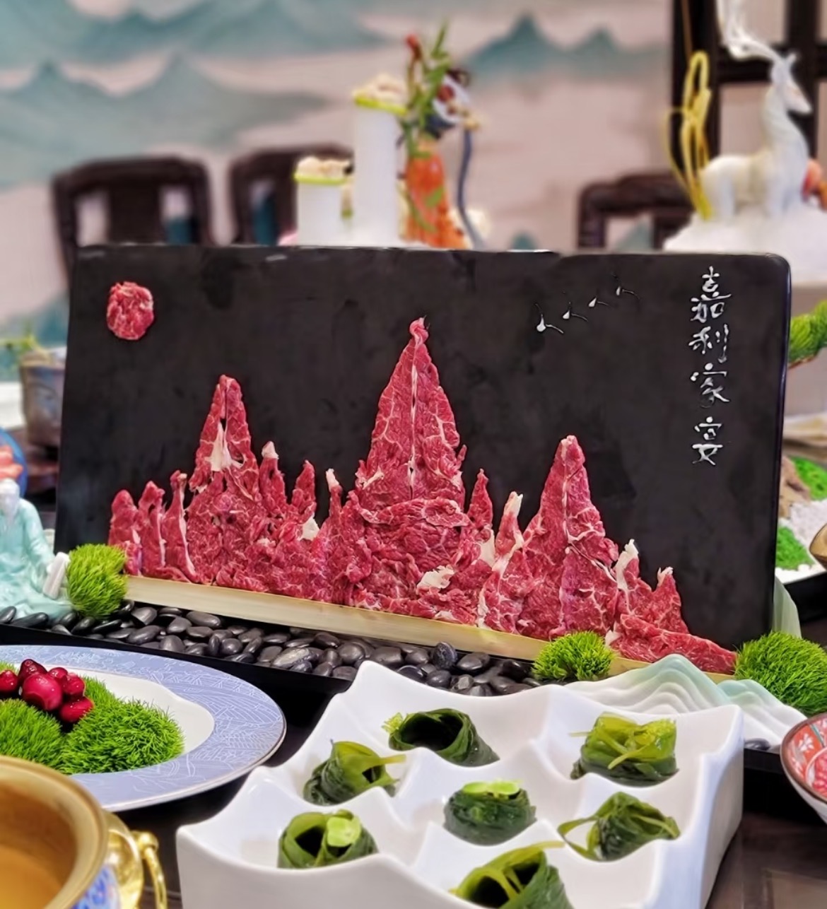Artistic sliced-beef mountain landscape plating on a slate board