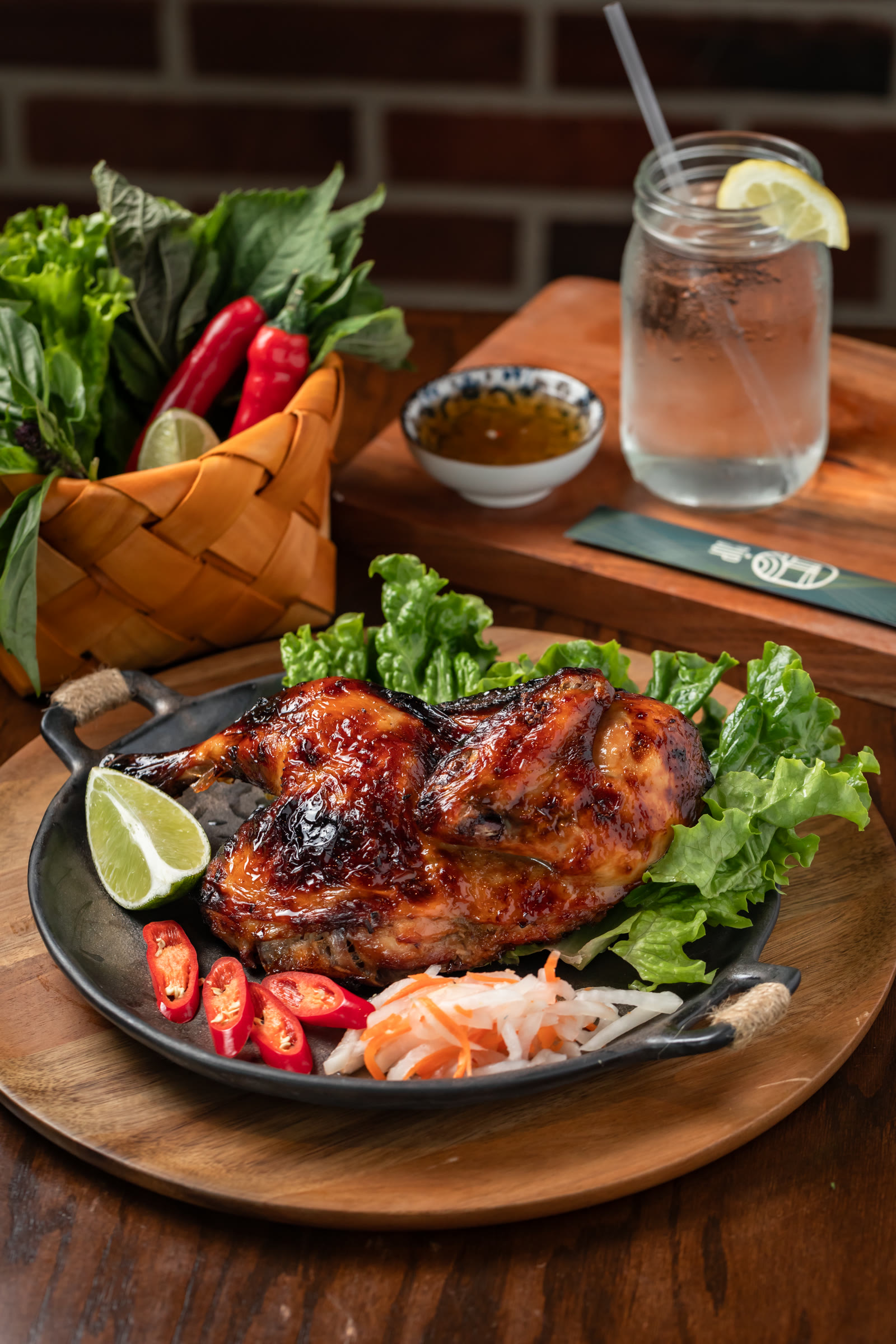 Glossy Vietnamese grilled chicken plate with herbs and pickles