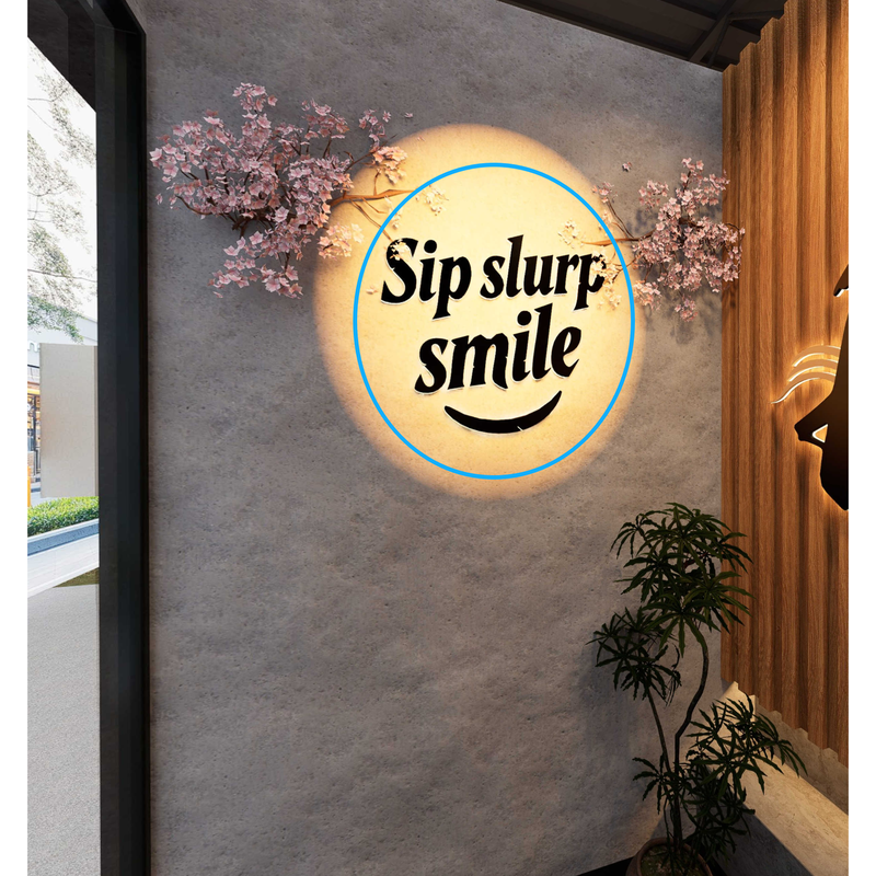 KAZE 'Sip slurp smile' branded signage render on a textured wall with cherry blossoms