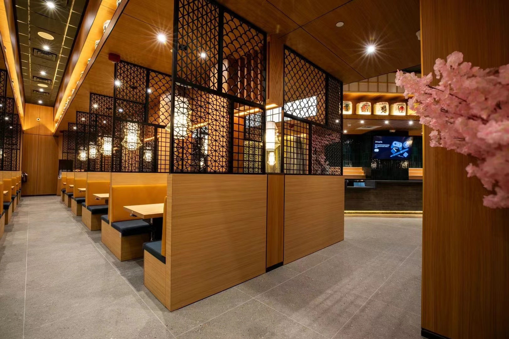 Real ramen restaurant booth seating with lattice screens, warm lighting and cherry blossoms